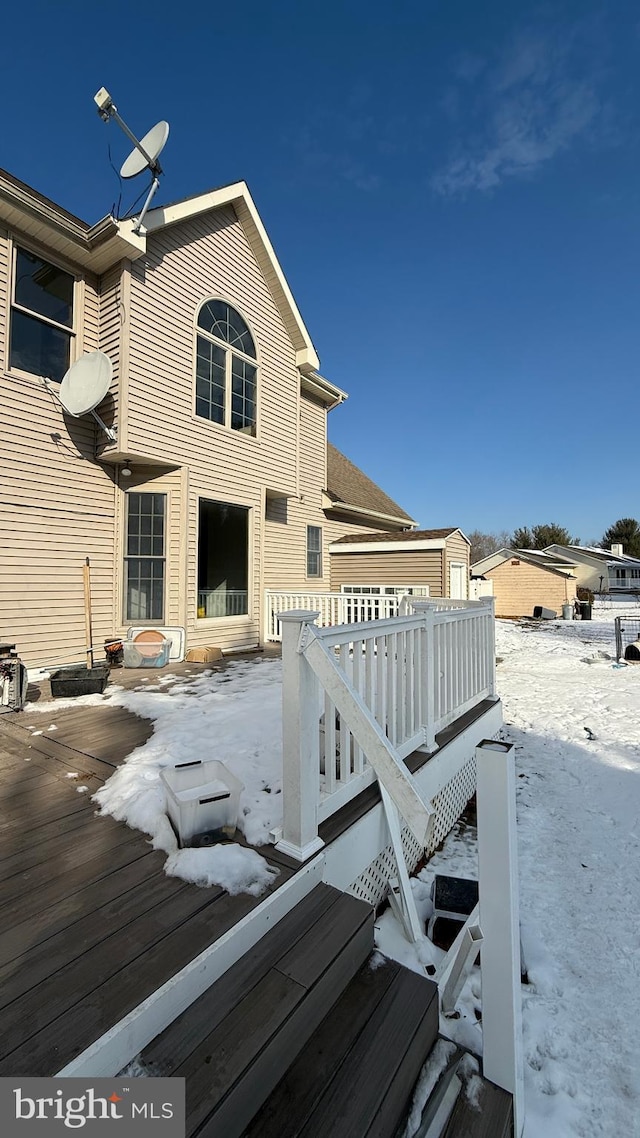 snow covered deck with a garage