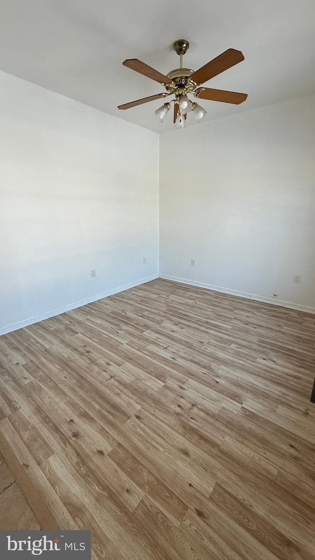 empty room with ceiling fan and light wood-type flooring