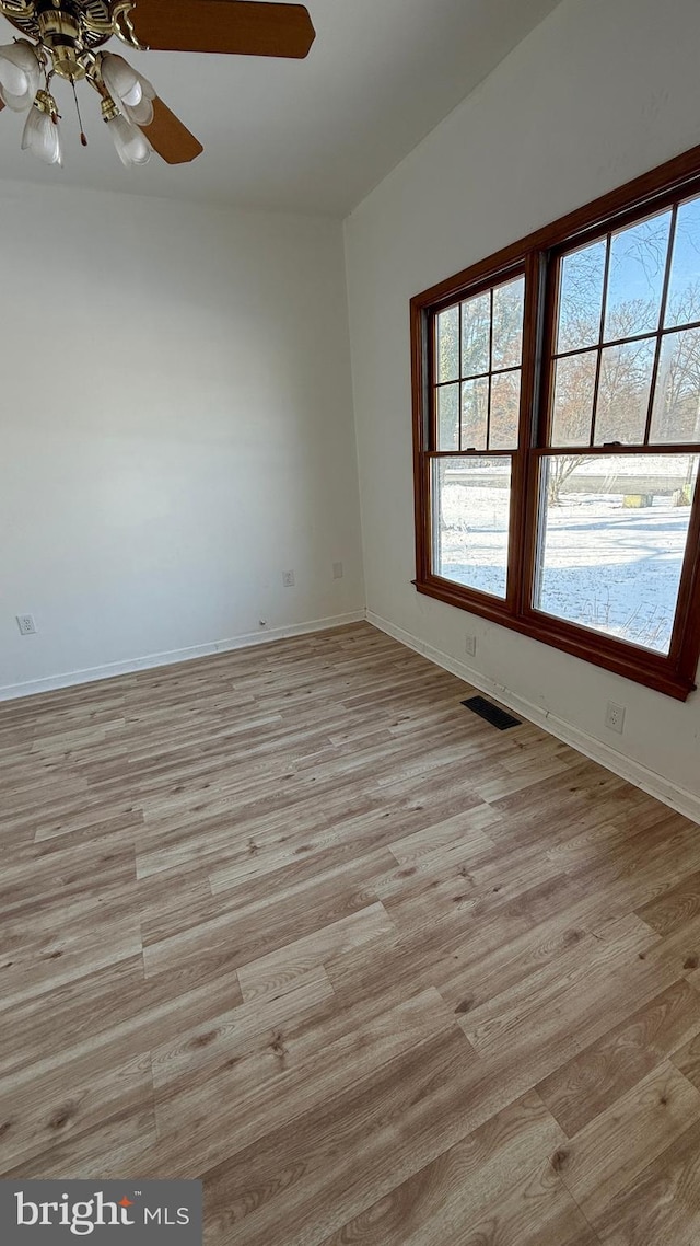 spare room featuring ceiling fan and light hardwood / wood-style floors