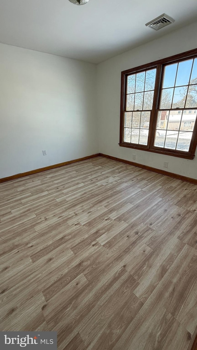 spare room featuring light hardwood / wood-style floors