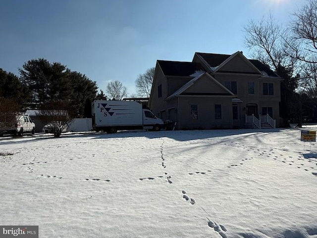 view of snow covered rear of property