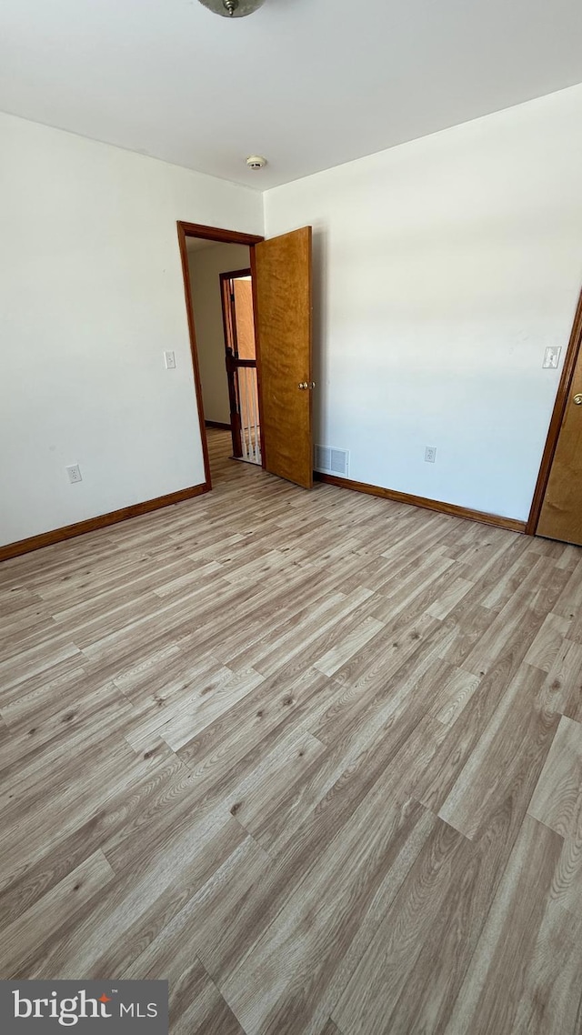 unfurnished room with light hardwood / wood-style floors