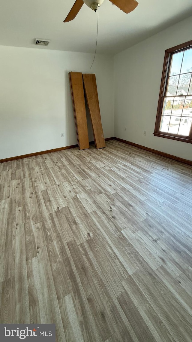 unfurnished room featuring ceiling fan and light hardwood / wood-style floors