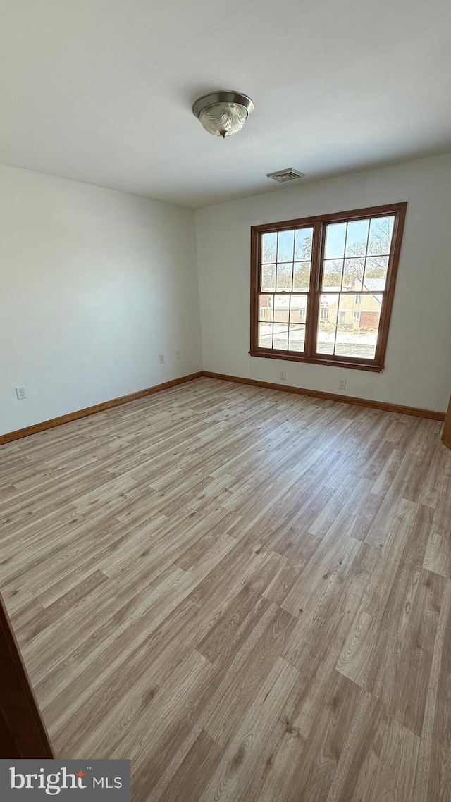 spare room featuring light wood-type flooring