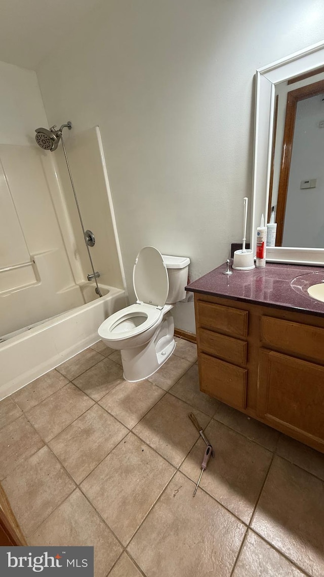 full bathroom with shower / tub combination, vanity, tile patterned floors, and toilet