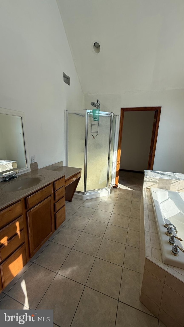 bathroom with shower with separate bathtub, vanity, tile patterned flooring, and high vaulted ceiling