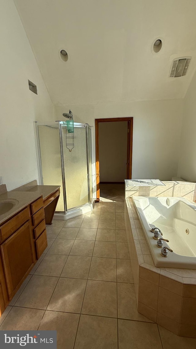 bathroom featuring tile patterned flooring, vaulted ceiling, vanity, and shower with separate bathtub