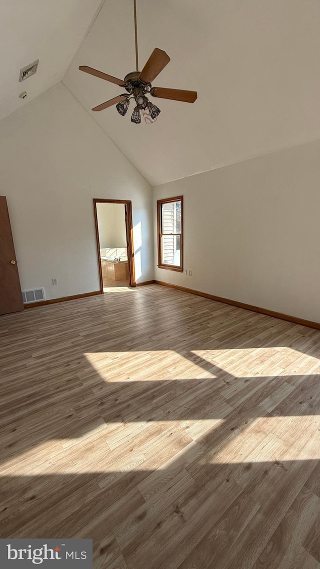 spare room with ceiling fan, light hardwood / wood-style floors, and high vaulted ceiling