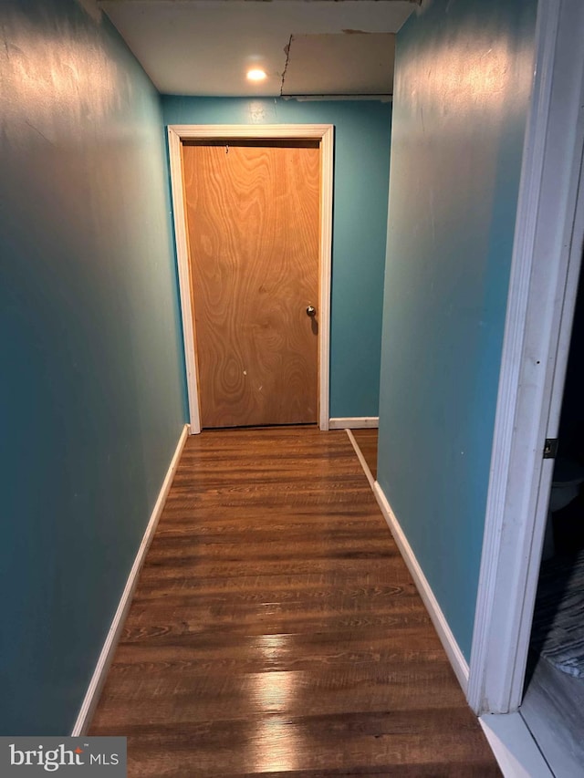 corridor with dark hardwood / wood-style floors