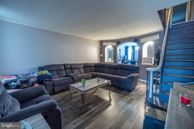 living room featuring dark hardwood / wood-style flooring and ornamental molding