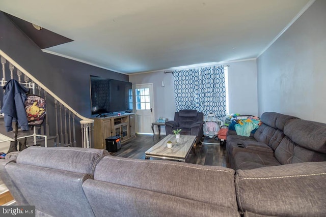 living room with dark hardwood / wood-style floors and crown molding