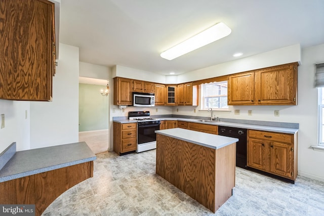 kitchen featuring sink, dishwasher, white gas stove, and a kitchen island