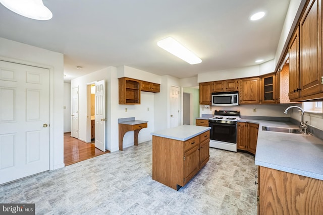 kitchen featuring a kitchen island, sink, and gas range gas stove