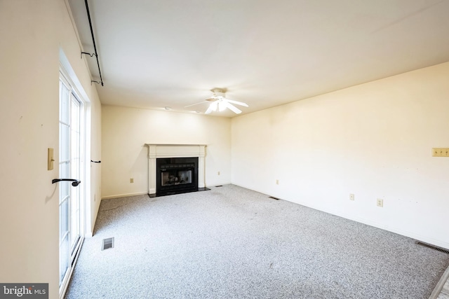 unfurnished living room with ceiling fan and light carpet