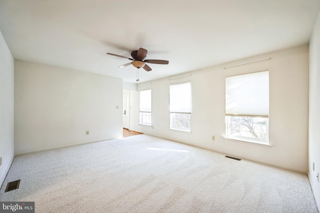 carpeted empty room featuring ceiling fan