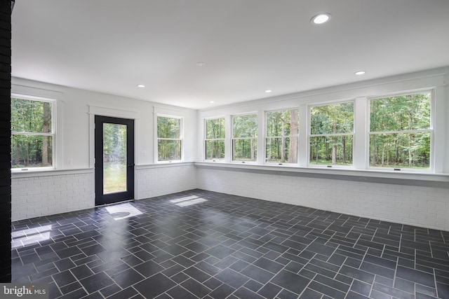 unfurnished sunroom featuring plenty of natural light