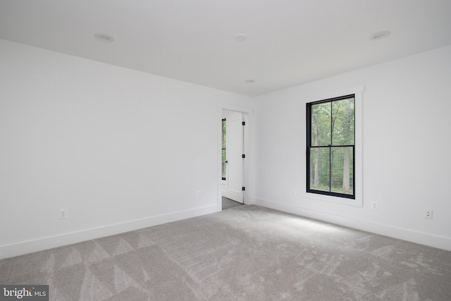 unfurnished room with light colored carpet