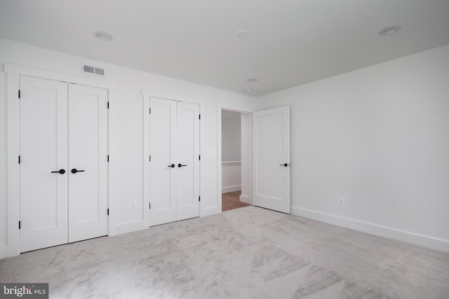 unfurnished bedroom with light carpet