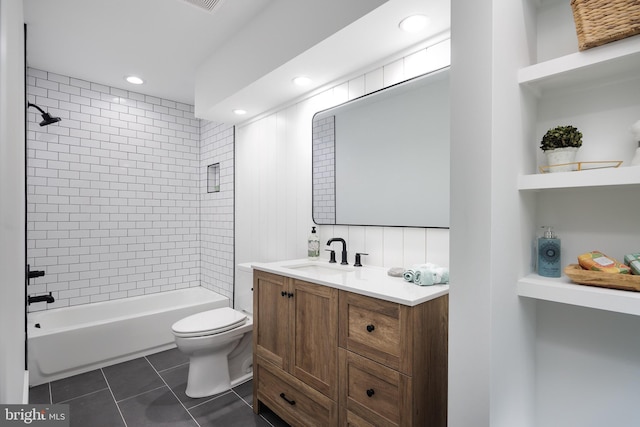 full bathroom with tile patterned floors, vanity, toilet, and tiled shower / bath combo