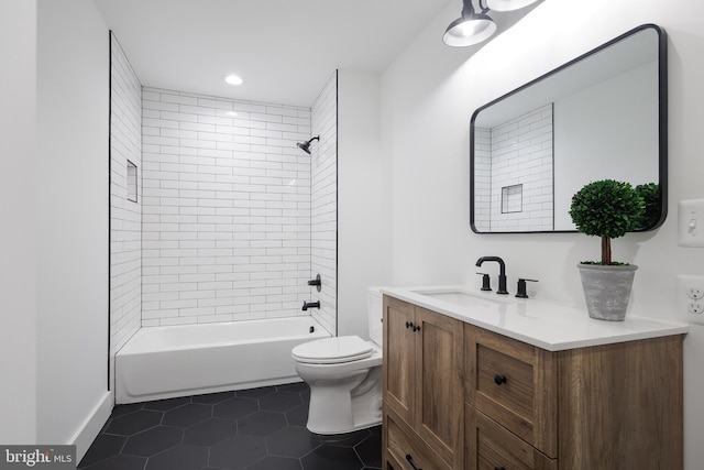 full bathroom with tile patterned flooring, vanity, toilet, and tiled shower / bath