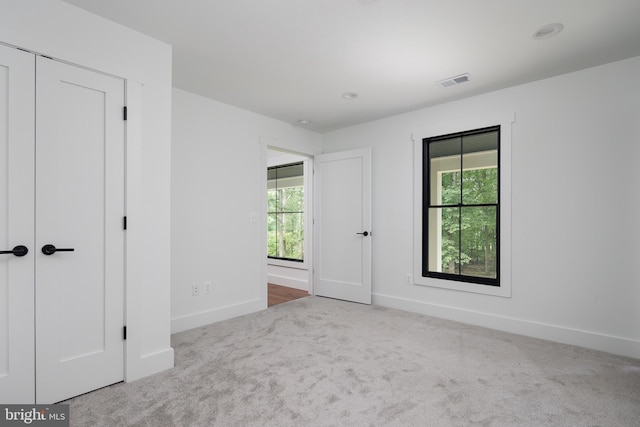 carpeted empty room featuring plenty of natural light