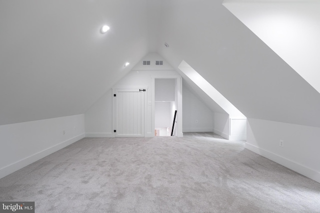 additional living space with light carpet and lofted ceiling