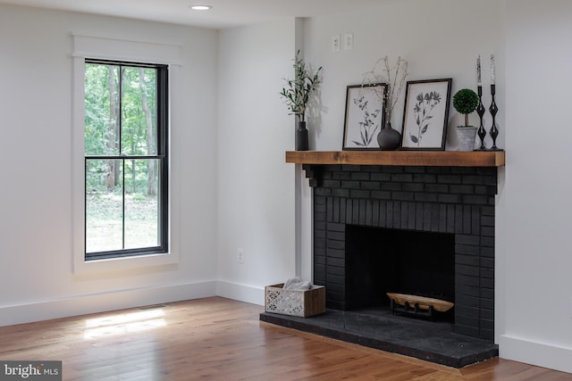 living room with hardwood / wood-style flooring and a fireplace