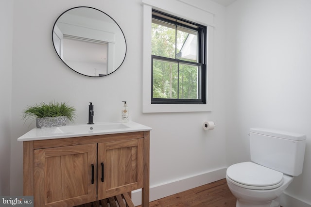 bathroom featuring hardwood / wood-style flooring, vanity, and toilet