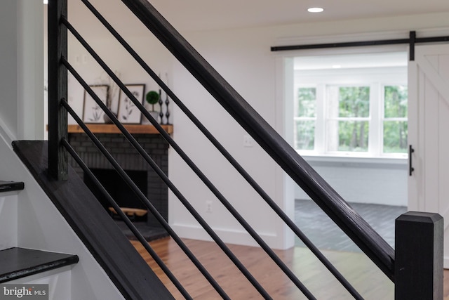 stairway featuring hardwood / wood-style floors and a barn door