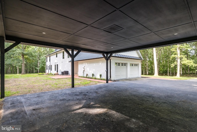 garage featuring a yard and central AC