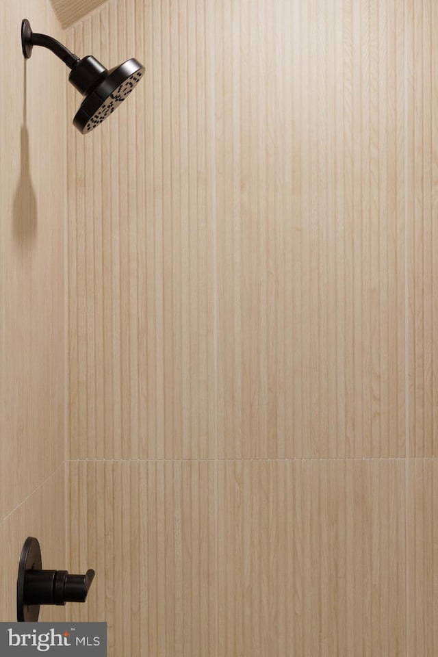 interior details featuring a tile shower