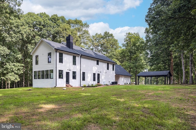 rear view of house featuring a gazebo, a yard, and cooling unit