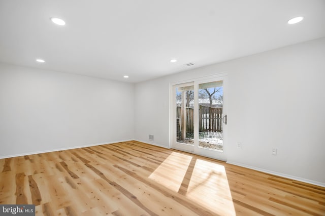 empty room with light hardwood / wood-style floors