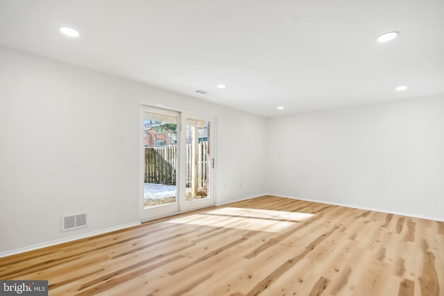 spare room with light hardwood / wood-style flooring