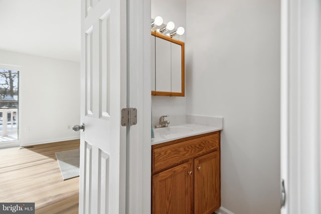 bathroom with vanity and hardwood / wood-style flooring