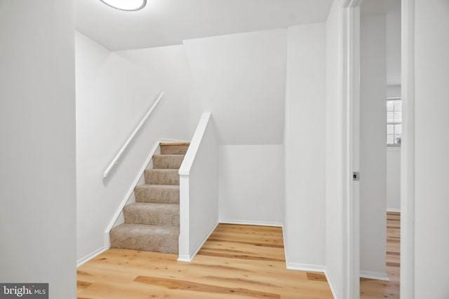 stairs featuring hardwood / wood-style floors