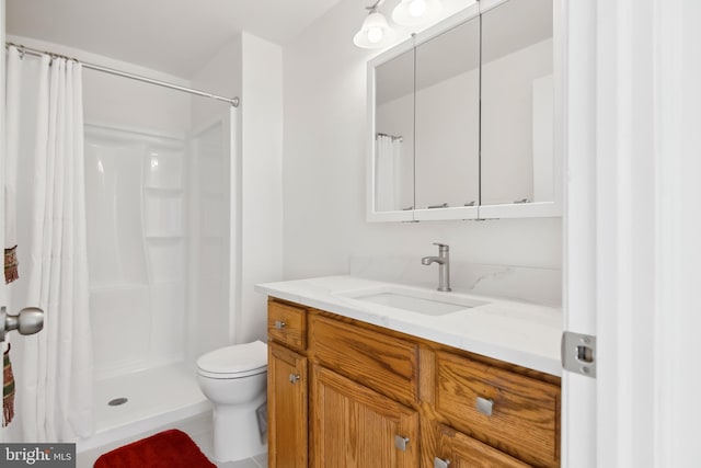 bathroom with vanity, walk in shower, and toilet