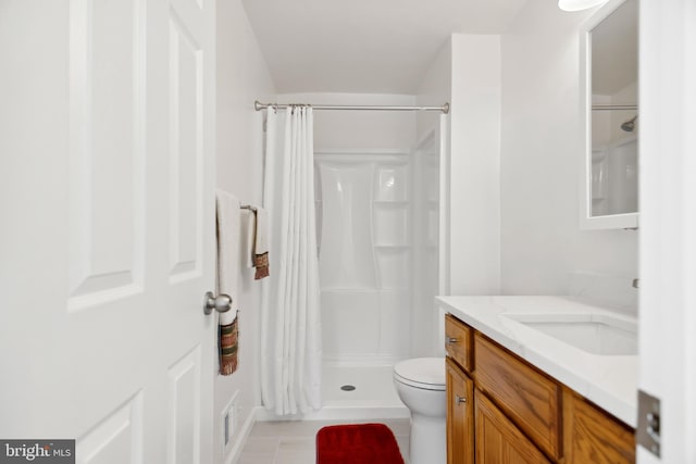 bathroom featuring walk in shower, tile patterned floors, vanity, and toilet