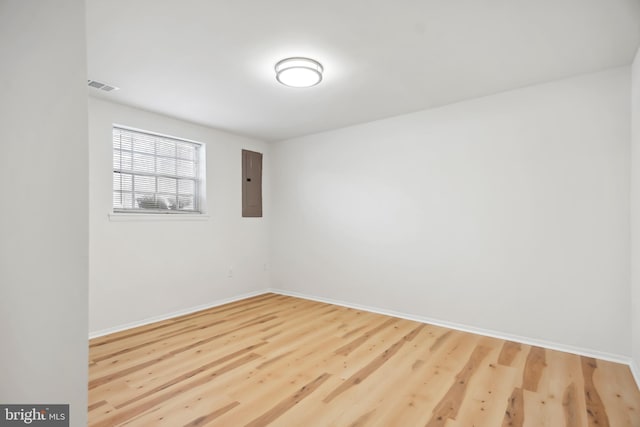 unfurnished room featuring wood-type flooring and electric panel