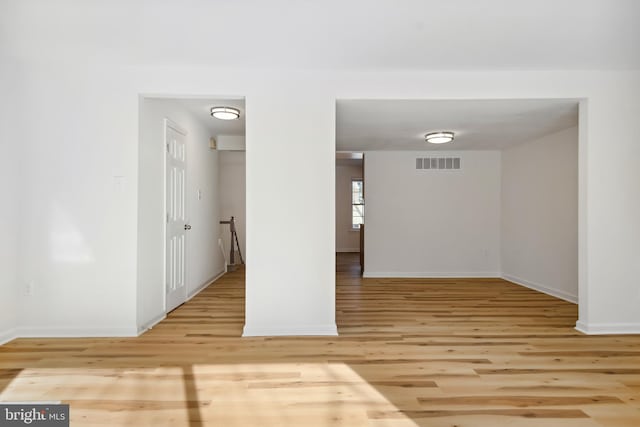 unfurnished room with light wood-type flooring