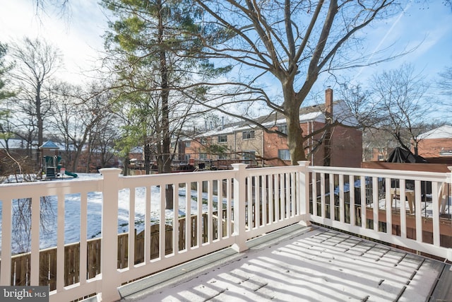 wooden terrace featuring a playground