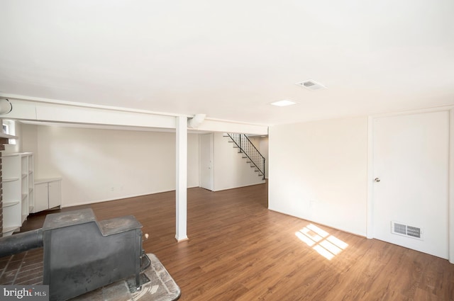 basement with dark hardwood / wood-style flooring