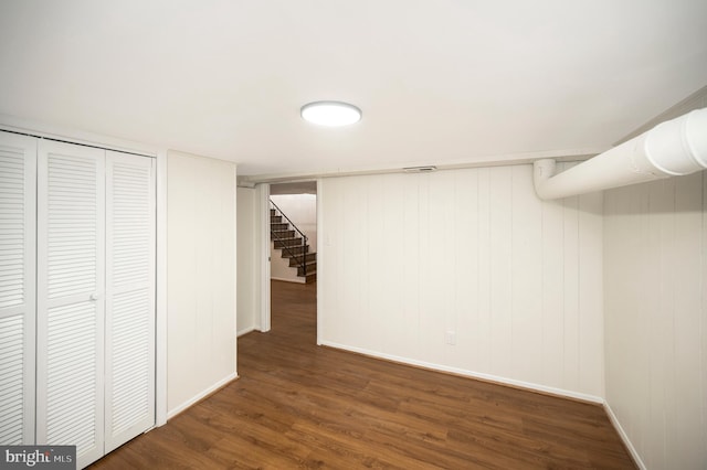 basement with dark hardwood / wood-style flooring