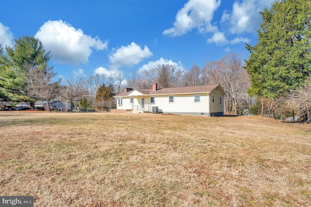 back of property featuring a yard