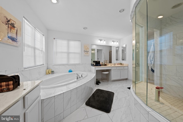 bathroom with vanity and independent shower and bath