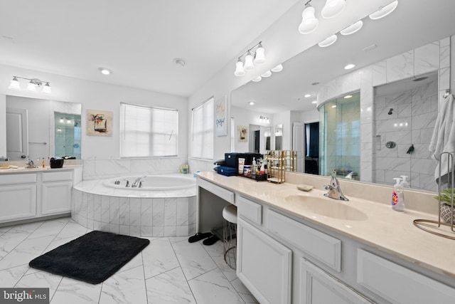 bathroom featuring separate shower and tub and vanity