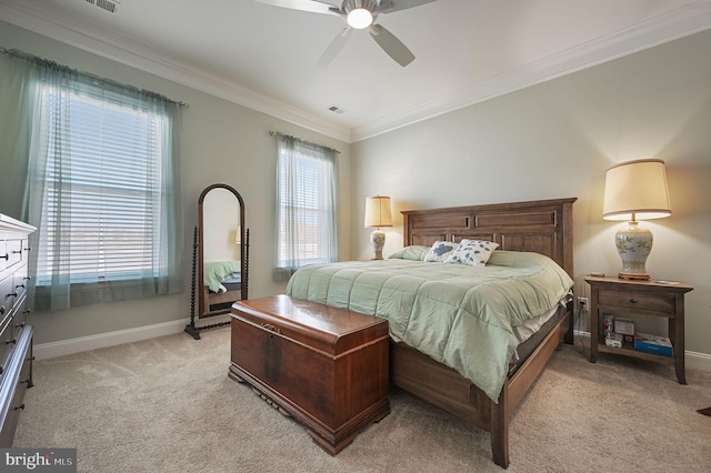 carpeted bedroom with ceiling fan and crown molding