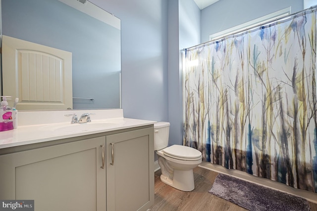 full bathroom featuring toilet, vanity, shower / bath combo, and hardwood / wood-style floors