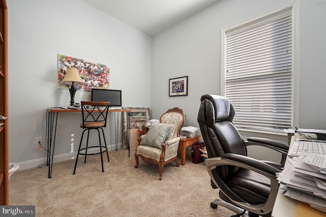 office area featuring vaulted ceiling and light carpet