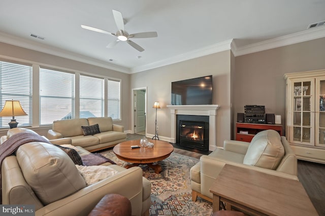 living room featuring ceiling fan, dark hardwood / wood-style flooring, and ornamental molding